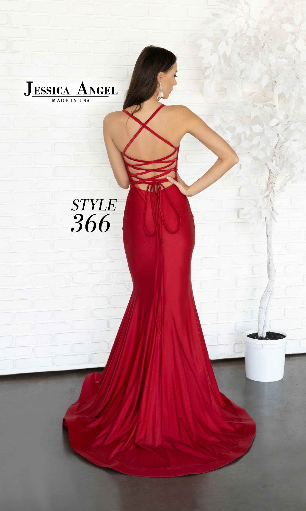 A woman models the Lace-Up Long Prom Dress: Jessica Angel 366, a floor-length red gown with an open back, crisscross straps, and a fitted silhouette.